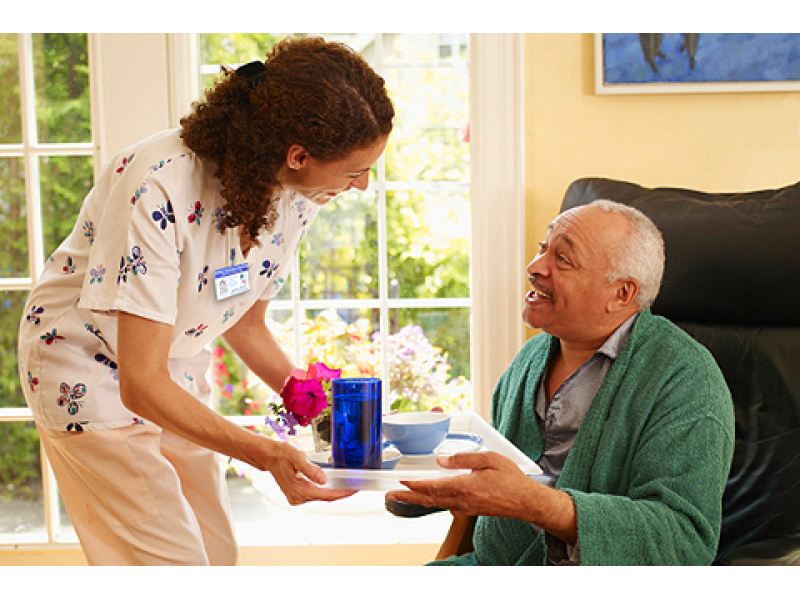 Care giver helping elderly man