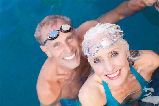 Older couple swiming in a pool